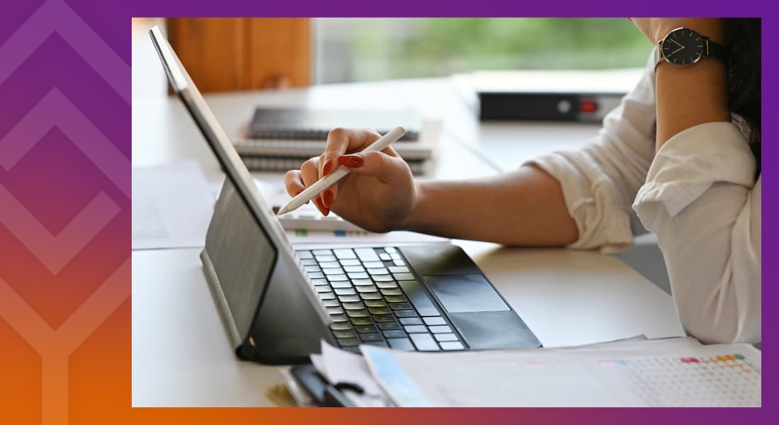 Person sitting at a table working on a laptop