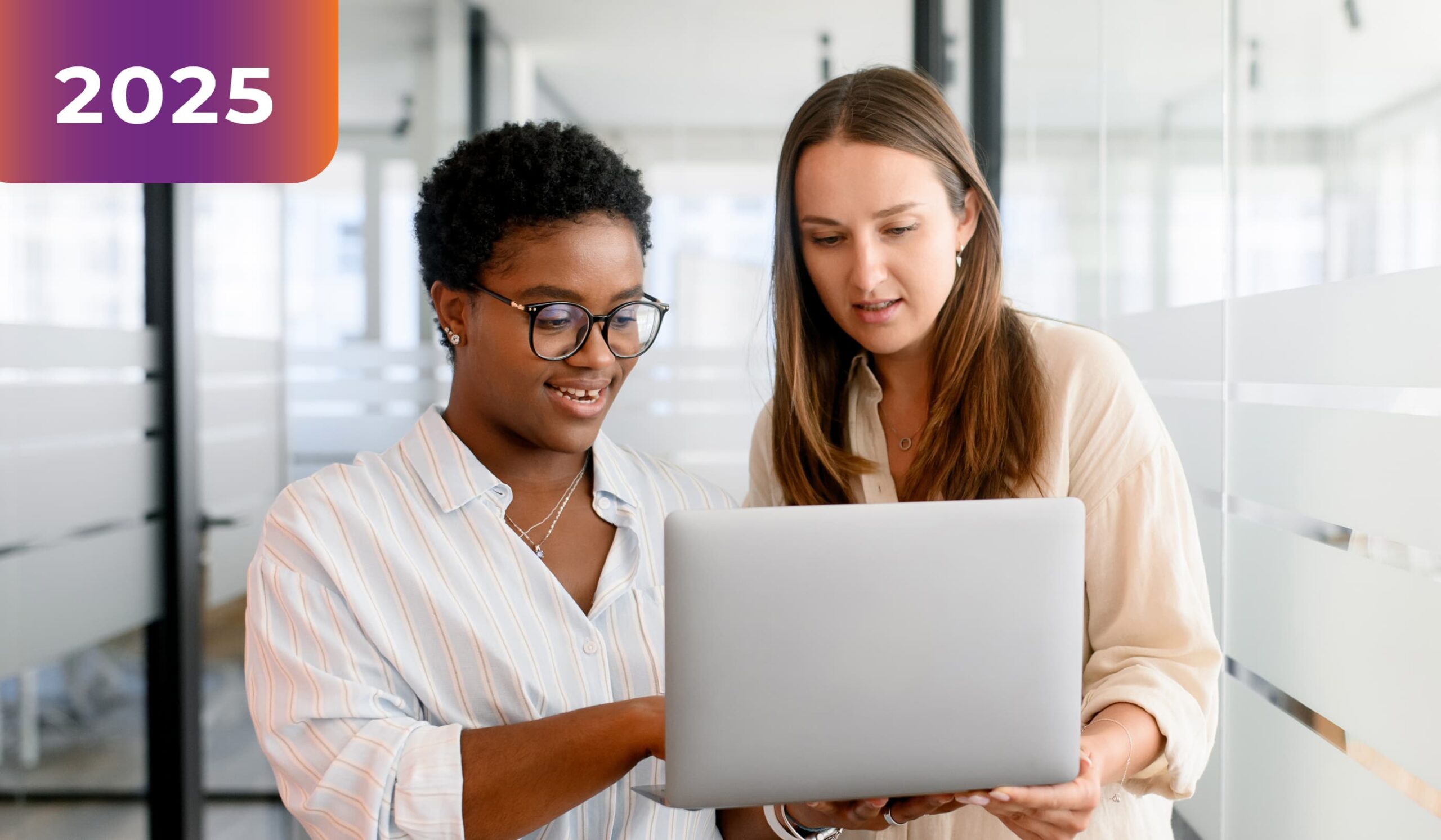 Two people looking at a laptop